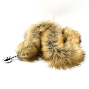Metal plug with attached fluffy red fox tail on white background