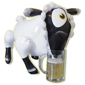 Inflatable sheep toy with black and white coloring, head positioned over a glass beer mug